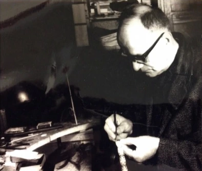 An archival photograph of jewellery being worked on at the bench