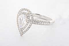 A pear-shaped ring with a halo of smaller stones